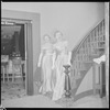 Unidentified woman in gown on staircase