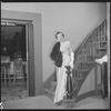 Unidentified woman in gown on staircase