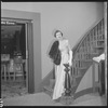 Unidentified woman in gown on staircase