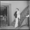 Unidentified woman in gown on staircase