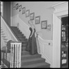 Unidentified woman in gown on staircase