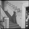 Unidentified woman in gown on staircase