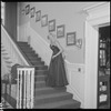 Unidentified woman in gown on staircase