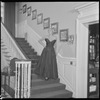Unidentified woman in gown on staircase