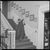 Unidentified woman in gown on staircase