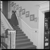 Unidentified woman in gown on staircase