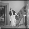 Unidentified woman in gown on staircase
