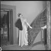 Unidentified woman in gown on staircase