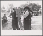 Greensboro chief of police reading CIO picket sign at a textile mill in Greensboro, Greene County, Georgia.