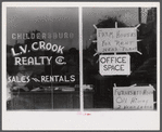 Real estate agent's window, Childersburg, Alabama.