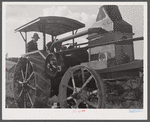 Tractor engine used to operate threshing machine at the farm of Alfred Shaffner, in submarginal farm area of Sugar Hill, near Townsend, New York.