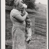 Farm woman holding one of her children in submarginal farm area of Rumsey Hill, near Erin, New York.