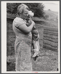 Farm woman holding one of her children in submarginal farm area of Rumsey Hill, near Erin, New York.