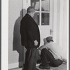 On a rainy day, Mr. Addison FSA (Farm Security Administration) client and his son are repairing the floor of their house near Middlefield, Connecticut.