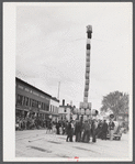 The "Pototem pole" standing in the main street of Presque Isle as an advertising stunt for the barrel rolling contest in Presque Isle, Maine.