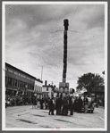 The "Pototem pole" standing in the main street of Presque Isle as an advertising stunt for the barrel rolling contest in Presque Isle, Maine.