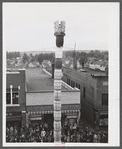 The "Pototem" pole standing in the main street of Presque Isle, Maine, as an advertisement for the barrel rolling contest.
