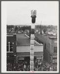 The "Pototem" pole standing in the main street of Presque Isle, Maine, as an advertisement for the barrel rolling contest.