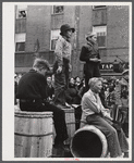 Younsters watching the men's race at the barrel rolling contest in Presque Isle, Maine.