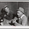 Workmen at the Woodman Potato Company just finishing lunch in the small room in the storehouse that serves as a lunchroom.