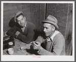 Workmen at the Woodman Potato Company just finishing lunch in the small room in the storehouse that serves as a lunchroom.