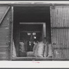 Loading sacks of potatoes into a car of the Bangor and Aroostock Railroad for shipment. Caribou, Maine.