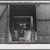 Loading sacks of potatoes into a car of the Bangor and Aroostock Railroad for shipment. Caribou, Maine.