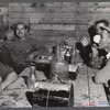 Workmen at the Woodman Potato Company just finishing lunch in a small room at the store house that serves as a lunchroom. Caribou, Maine.