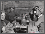 Workmen at the Woodman Potato Company just finishing lunch in a small room at the store house that serves as a lunchroom. Caribou, Maine.