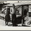Mr. and Mrs. Thompson standing in front of their log and peat cabin. Thompson reckoned that he had had three crops out of nine on the land. Necedah project, Wisconsin.
