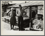 Mr. and Mrs. Thompson standing in front of their log and peat cabin. Thompson reckoned that he had had three crops out of nine on the land. Necedah project, Wisconsin.
