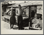Mr. and Mrs. Thompson standing in front of their log and peat cabin. Thompson reckoned that he had had three crops out of nine on the land. Necedah project, Wisconsin.