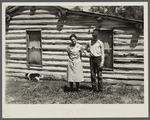 Mrs. Cornelius and son standing by their log house, homesteaded in 1912. They will be resettled. Beltrami Island reforestation project, Minnesota.