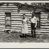 Mrs. Cornelius and son standing by their log house, homesteaded in 1912. They will be resettled. Beltrami Island reforestation project, Minnesota.