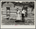 Mrs. Cornelius and son standing by their log house, homesteaded in 1912. They will be resettled. Beltrami Island reforestation project, Minnesota.