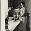Homesteader canning vegetables in her new kitchen. Austin Homesteads, Minnesota.