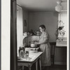Homesteader canning vegetables in her new kitchen. Austin Homesteads, Minnesota.