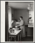 Homesteader canning vegetables in her new kitchen. Austin Homesteads, Minnesota.