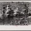 Washing clothes in the river near the slum area known as "El Machuelitto" in Ponce, Puerto Rico.