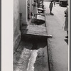 An open sewer on one of the main streets in Christiansted, Virgin Islands.