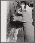 An open sewer on one of the main streets in Christiansted, Virgin Islands.