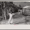 Farmer's wife carrying brushwood to her home in the hills near Yauco, Puerto Rico.
