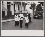 A funeral procession along the main street in Yauco, Puerto Rico.