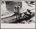 Children sitting on one of the boardwalks which are as sidewalks in the slum area known as "El Fangitto" (The Mud) in San Juan, Puerto Rico.