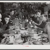 Lunch hour at one of the farms of the Woodman Potato Company. All of the pickers and field laborers eat in this converted tool house, eleven miles north of Caribou, Maine.