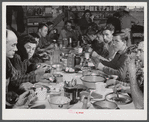 Lunch hour at one of the farms of the Woodman Potato Company. All of the pickers and field laborers eat in this converted tool house, eleven miles north of Caribou, Maine.