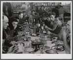 Lunch hour at one of the farms of the Woodman Potato Company. All of the pickers and field laborers eat in this converted tool house, eleven miles north of Caribou, Maine.