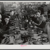 Lunch hour at one of the farms of the Woodman Potato Company. All of the pickers and field laborers eat in this converted tool house, eleven miles north of Caribou, Maine.