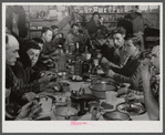 Lunch hour at one of the farms of the Woodman Potato Company. All of the pickers and field laborers eat in this converted tool house, eleven miles north of Caribou, Maine.