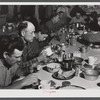 Lunch hour at one of the farms of the Woodman Potato Company. All of the pickers and field laborers eat in this converted toolhouse. Eleven miles north of Caribou, Maine.